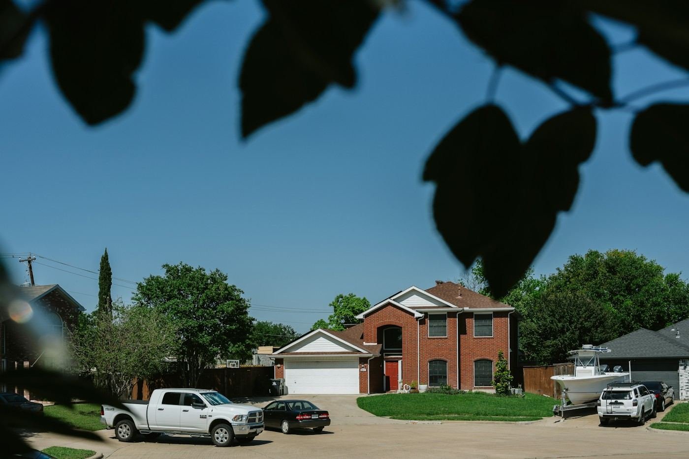 A two-story brick home on a suburban cul-de-sac